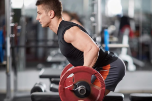 muscular man lifting weights in a squatted position